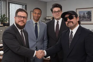 Aaron Rountree and Andrew Lee Jenkins shaking hands in an office